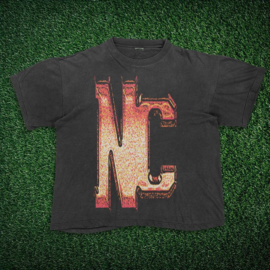 Black tee with a bold fiery NC letter graphic